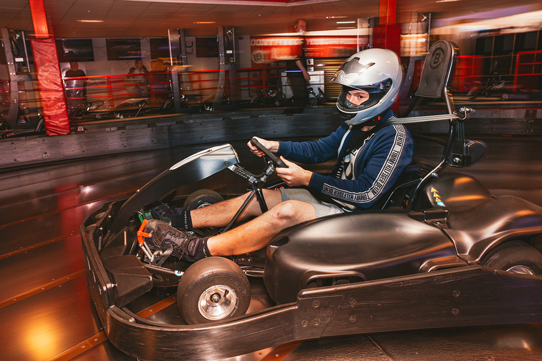 Person in a crash helmet driving a go-kart